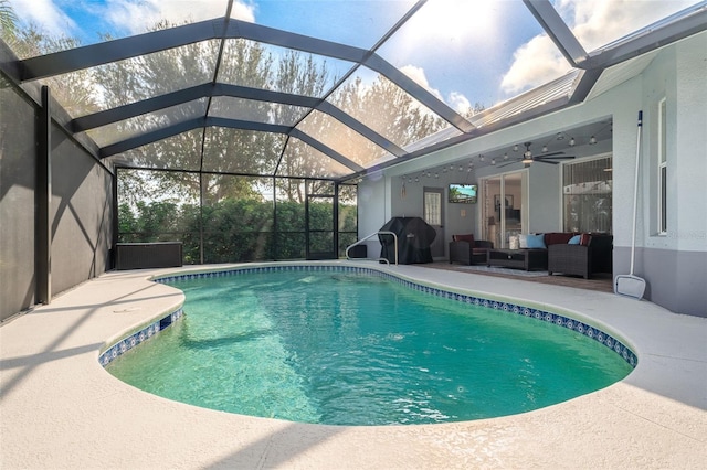 view of swimming pool featuring a lanai, a mountain view, ceiling fan, a grill, and an outdoor hangout area