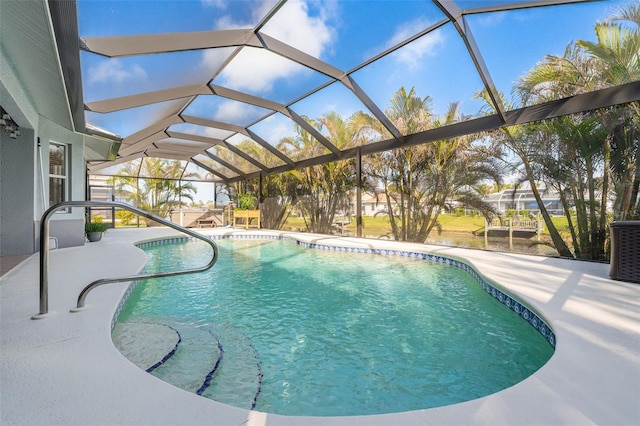 view of swimming pool with central AC unit, glass enclosure, and a patio area