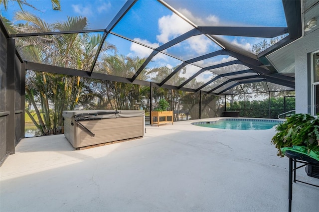 view of swimming pool featuring a lanai, a patio, and a hot tub