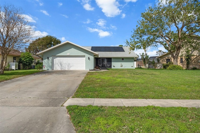 ranch-style home featuring a garage, solar panels, and a front lawn