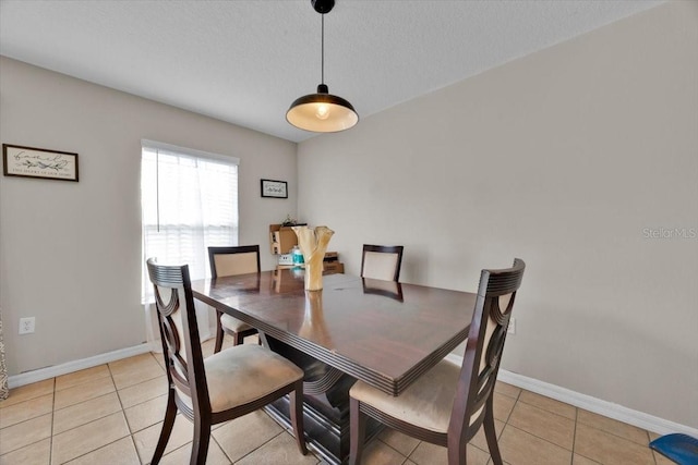 dining room featuring light tile patterned flooring and a textured ceiling