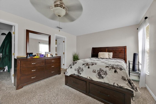 bedroom featuring light carpet and ceiling fan