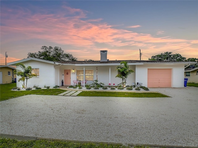 ranch-style home featuring a garage and a porch