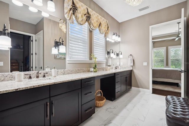 ensuite bathroom featuring ensuite bathroom, a sink, visible vents, marble finish floor, and double vanity