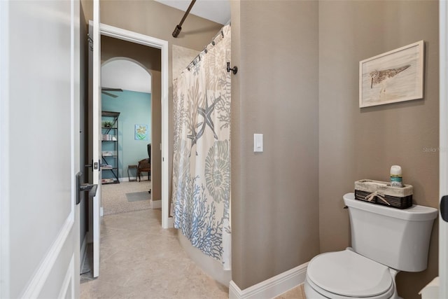 full bathroom featuring curtained shower, tile patterned floors, toilet, and baseboards