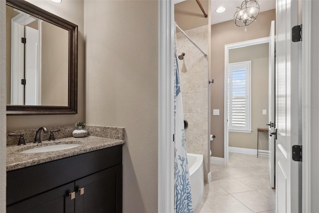 full bath featuring shower / bathing tub combination, tile patterned flooring, vanity, and baseboards