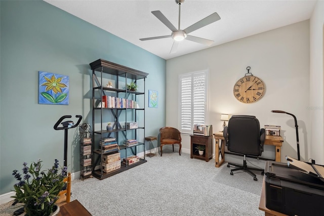 office space with carpet floors, baseboards, and a ceiling fan