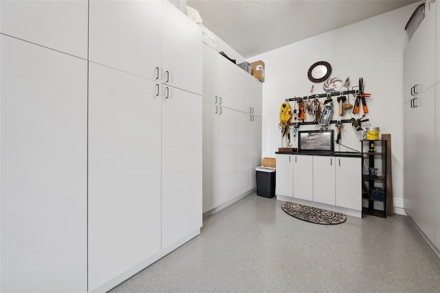 mudroom with light speckled floor and a textured ceiling