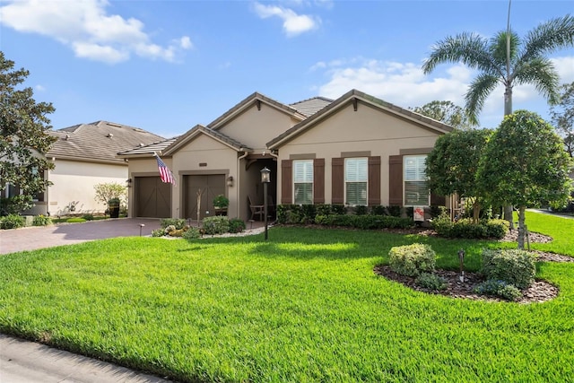 single story home with driveway, a garage, stucco siding, a tile roof, and a front yard