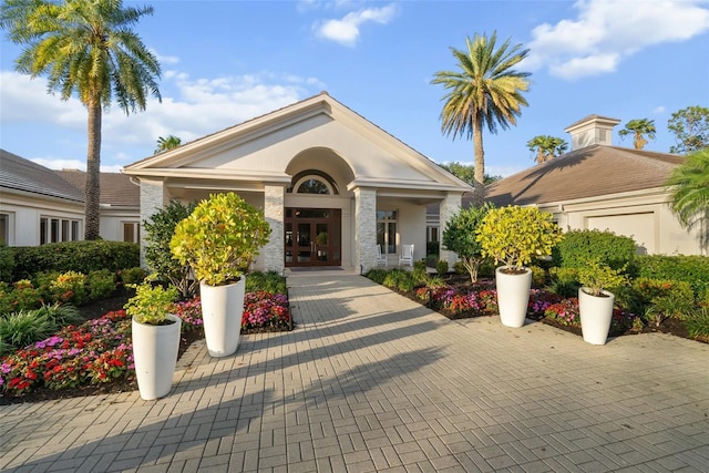 view of front of house with french doors and stucco siding