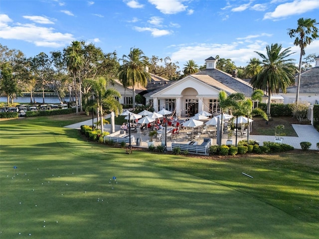 view of property's community with a water view and a yard