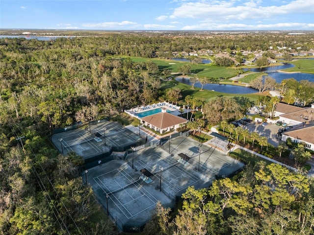 bird's eye view with a water view, a wooded view, and golf course view