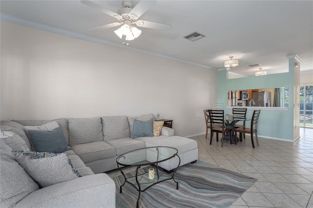 living room featuring crown molding, ceiling fan, and light tile patterned floors