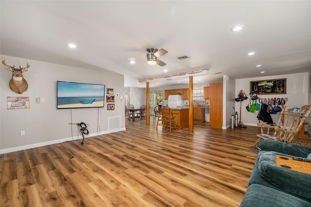 living area with recessed lighting, visible vents, light wood-style floors, and a ceiling fan