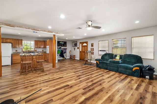 living room with visible vents, recessed lighting, light wood finished floors, baseboards, and ceiling fan