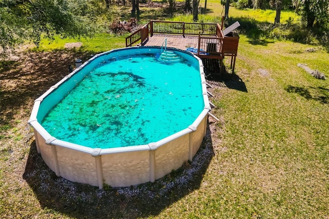 view of pool with a yard and a deck