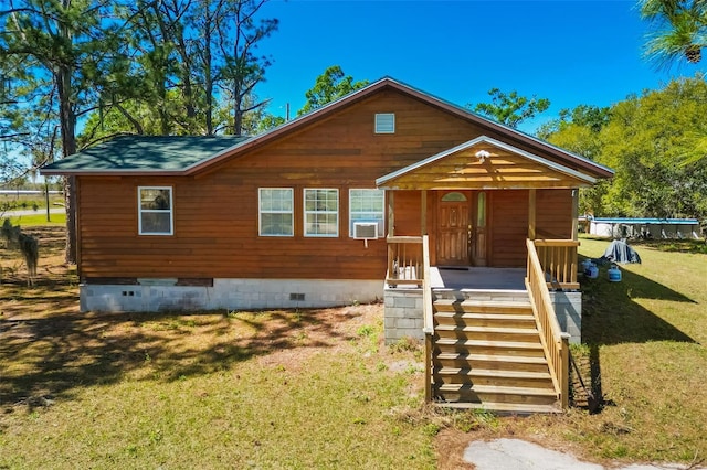 view of front facade with a front lawn, cooling unit, covered porch, and crawl space