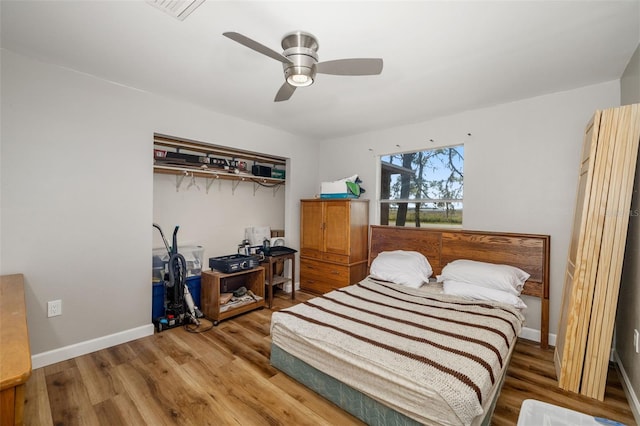 bedroom with visible vents, ceiling fan, baseboards, and wood finished floors