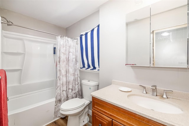 bathroom with vanity, toilet, wood finished floors, and shower / bath combo