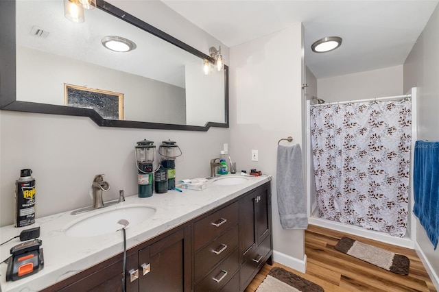 bathroom featuring visible vents, a shower stall, and a sink