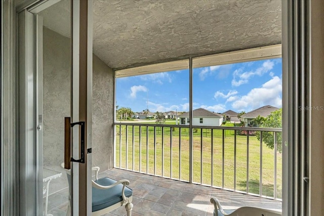 unfurnished sunroom with a residential view