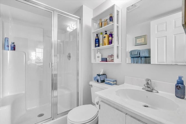 bathroom with toilet, a stall shower, visible vents, and vanity