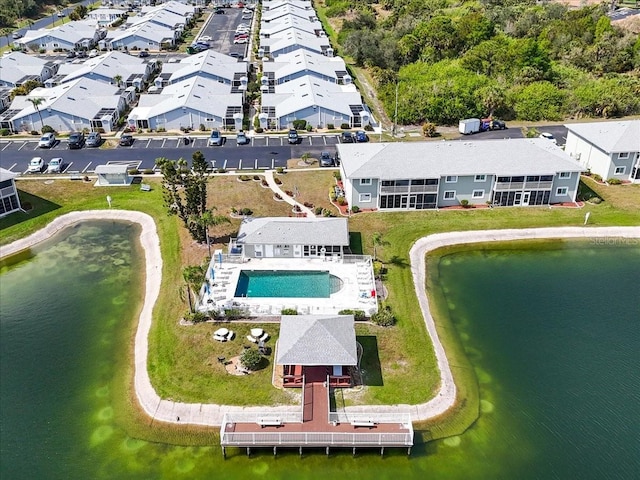 drone / aerial view with a residential view and a water view