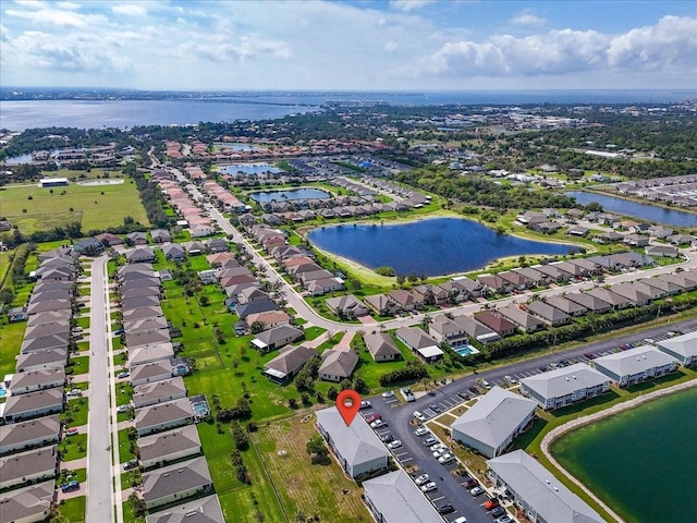 birds eye view of property with a water view and a residential view