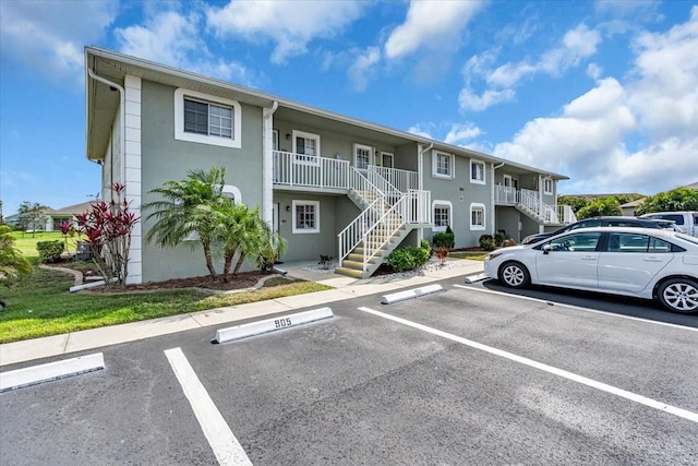 uncovered parking lot with stairs and a residential view