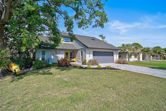 view of front of property with a garage, driveway, a front yard, and stucco siding