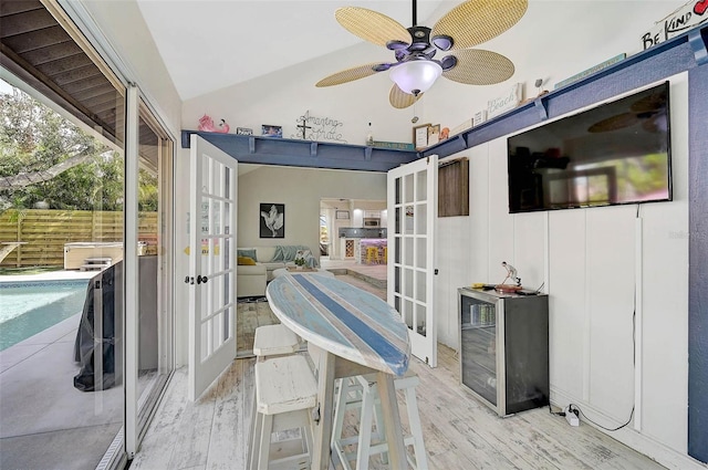 interior space featuring vaulted ceiling, ceiling fan, french doors, and a healthy amount of sunlight