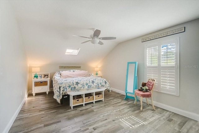 bedroom featuring lofted ceiling, ceiling fan, wood finished floors, and baseboards