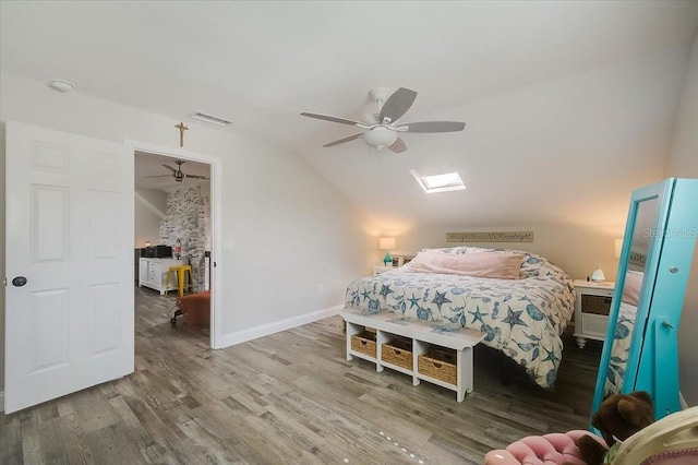 bedroom with visible vents, a ceiling fan, vaulted ceiling, wood finished floors, and baseboards