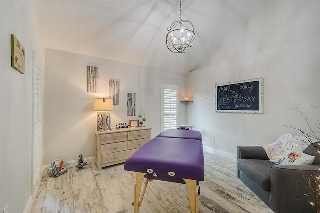 living area with vaulted ceiling, light wood finished floors, a notable chandelier, and baseboards