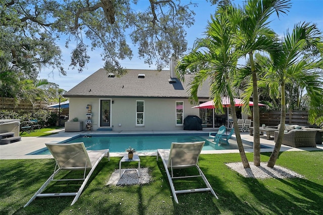 pool featuring a patio, fence, a lawn, and area for grilling