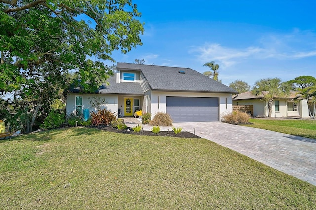 view of front of property with an attached garage, stucco siding, decorative driveway, and a front yard