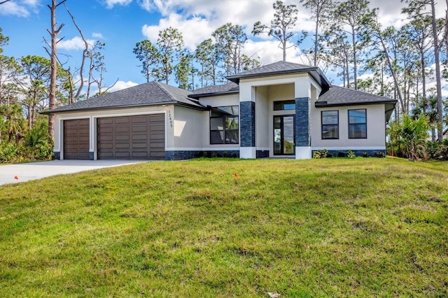 prairie-style house with a garage, driveway, a front yard, and stucco siding