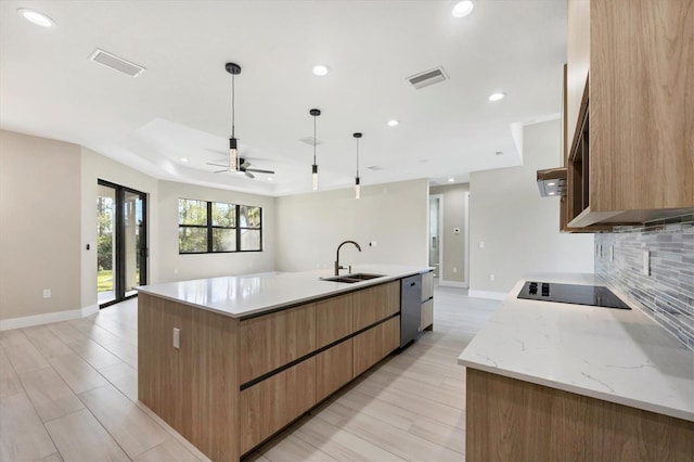 kitchen with visible vents, dishwasher, a large island, pendant lighting, and a sink