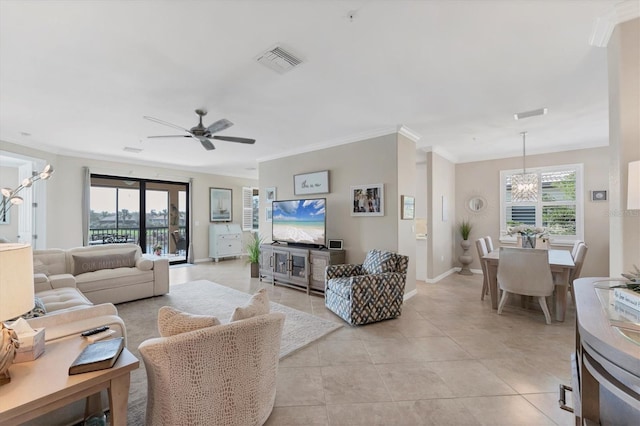 tiled living room featuring ceiling fan with notable chandelier and crown molding