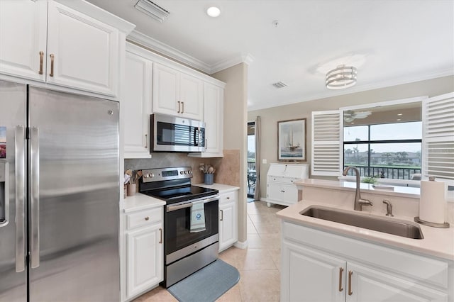 kitchen featuring stainless steel appliances, a sink, visible vents, white cabinetry, and light countertops