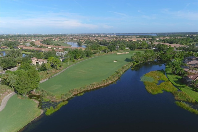 drone / aerial view featuring view of golf course and a water view