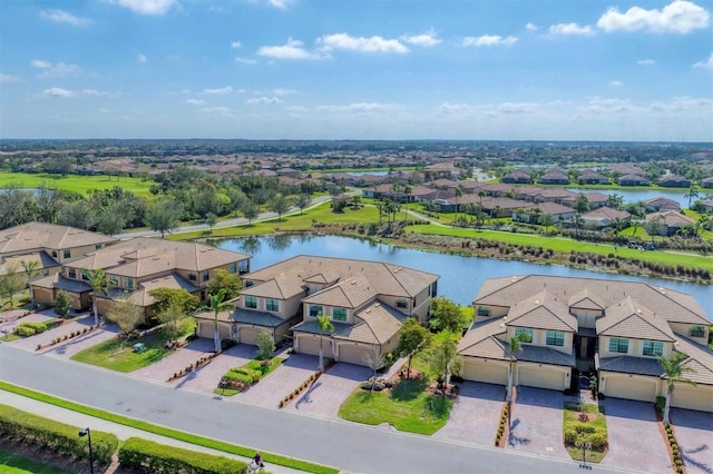 drone / aerial view with a water view and a residential view