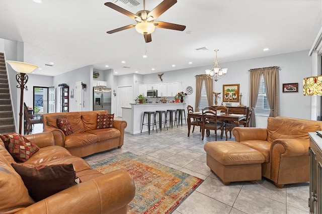 living room featuring light tile patterned floors, plenty of natural light, visible vents, stairway, and recessed lighting