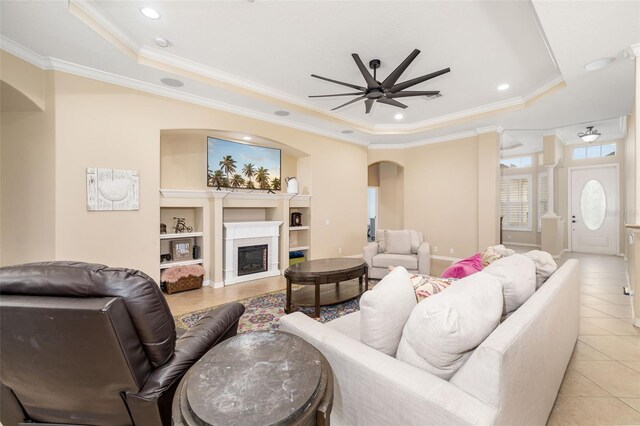 12211 Lavender Loop, Bradenton, FL 34212 - living area featuring a tray ceiling, arched walkways, ceiling fan, crown molding, and light tile patterned floors