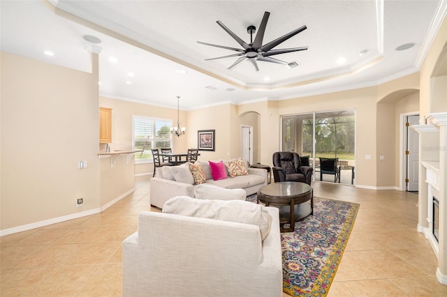 12211 Lavender Loop, Bradenton, FL 34212 - living room featuring arched walkways, a raised ceiling, light tile patterned floors, crown molding, and a ceiling fan