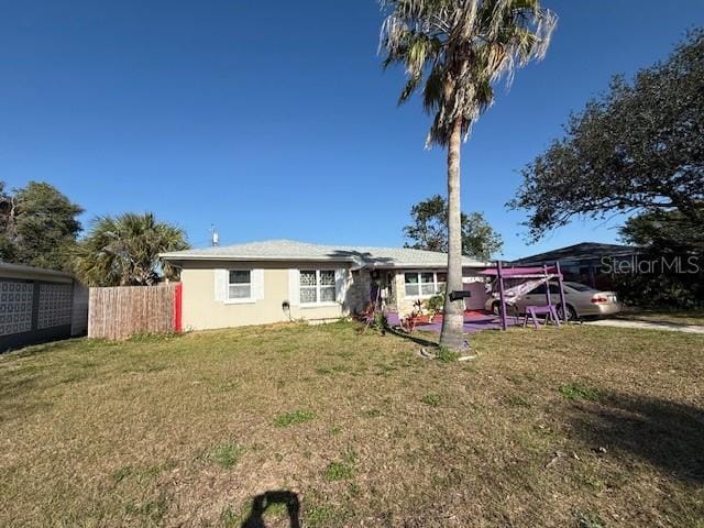 back of house featuring fence and a yard