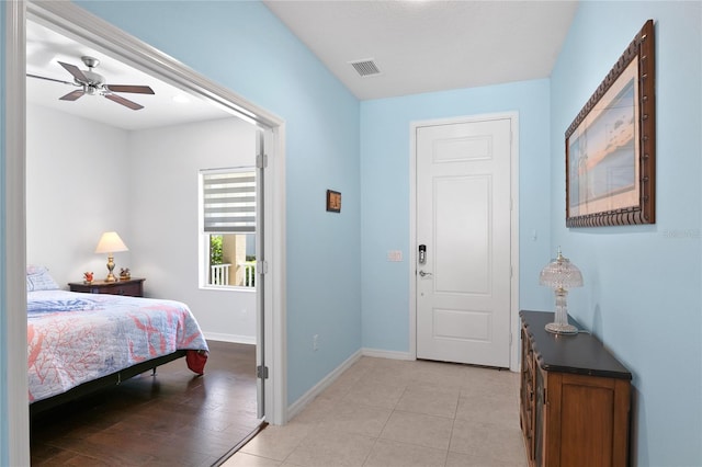 bedroom with ceiling fan and light tile patterned floors