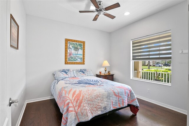 bedroom with ceiling fan and dark hardwood / wood-style flooring