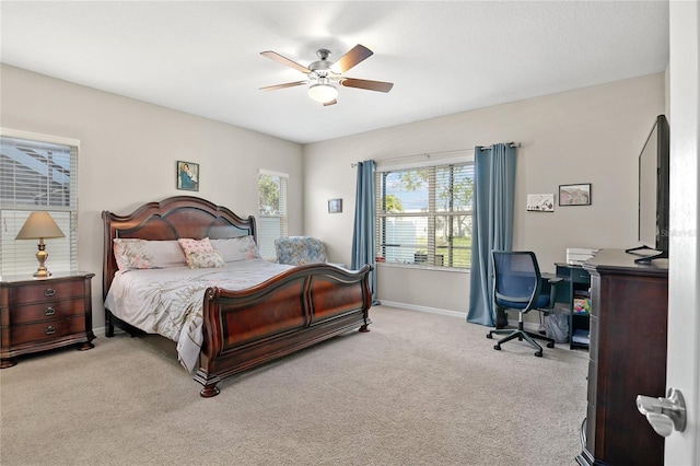 bedroom with ceiling fan and light colored carpet