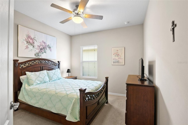 bedroom with ceiling fan and light carpet